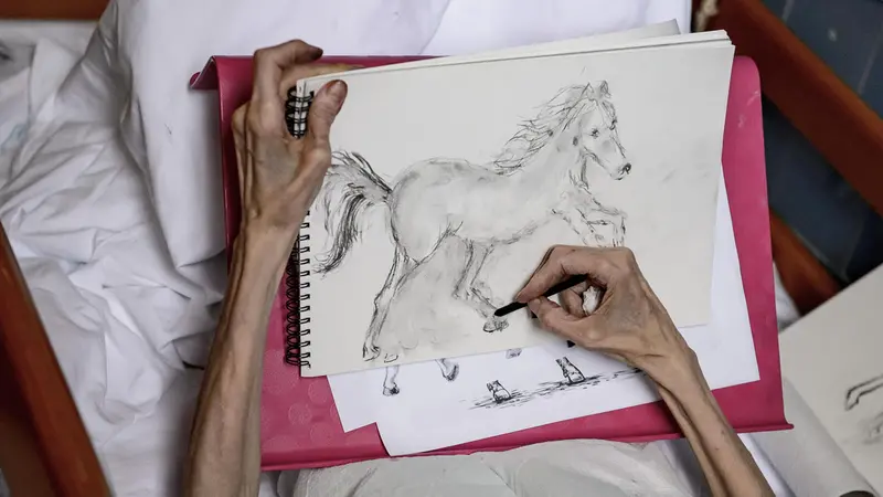 epa07912388 An elderly person draws in the Hospice Department of Markhot Ferenc Hospital in Eger, northern Hungary, 18 September 2019 (issued 11 October 2019). World Hospice and Palliative Care Day is observed annually on the second Saturday of October, which falls on 12 October this year with the motto 'My care is my right.' The first such event was organised in 2005 by a committee of the Worldwide Palliative Care Alliance, a wordwide network of hospice and palliative care organisations to draw attention to the needs of people who have been impacted by a life-limiting illness. Hospices operate to alleviate the pain and lessen the mental suffering of terminally ill patients while focusing on humane treatment and the protection of personal dignity. In Hungary, the foundraising events dedicated to the development of the hospice professsion on this special day are co-ordinated by the Hungarian Hospice-Palliative Association, which has been providing care for incurable cancer patients in Budapest since 1991. EPA/PETER KOMKA HUNGARY OUT - ATTENTION: This Image is part of a PHOTO SET