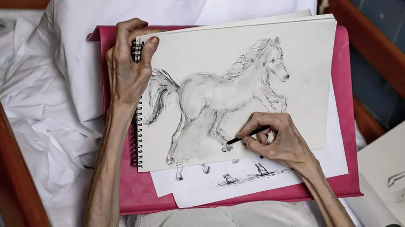 epa07912388 An elderly person draws in the Hospice Department of Markhot Ferenc Hospital in Eger, northern Hungary, 18 September 2019 (issued 11 October 2019). World Hospice and Palliative Care Day is observed annually on the second Saturday of October, which falls on 12 October this year with the motto 'My care is my right.' The first such event was organised in 2005 by a committee of the Worldwide Palliative Care Alliance, a wordwide network of hospice and palliative care organisations to draw attention to the needs of people who have been impacted by a life-limiting illness. Hospices operate to alleviate the pain and lessen the mental suffering of terminally ill patients while focusing on humane treatment and the protection of personal dignity. In Hungary, the foundraising events dedicated to the development of the hospice professsion on this special day are co-ordinated by the Hungarian Hospice-Palliative Association, which has been providing care for incurable cancer patients in Budapest since 1991. EPA/PETER KOMKA HUNGARY OUT - ATTENTION: This Image is part of a PHOTO SET