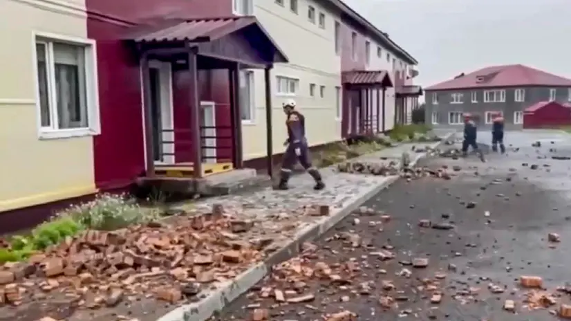 epa12272021 A still image taken from a handout video provided by the Russian Emergencies Ministry shows rescuers walking among debris in front of a damaged building following an earthquake, in Petropavlovsk-Kamchatsky, Kamchatka Krai, Russia, 30 July 2025. A 8.8 magnitude earthquake struck off Russia's Kamchatka Peninsula on 30 July, triggering tsunami warnings and evacuation orders. EPA/RUSSIAN EMERGENCIES MINISTRY HANDOUT --BEST QUALITY AVAILABLE--HANDOUT EDITORIAL USE ONLY/NO SALES