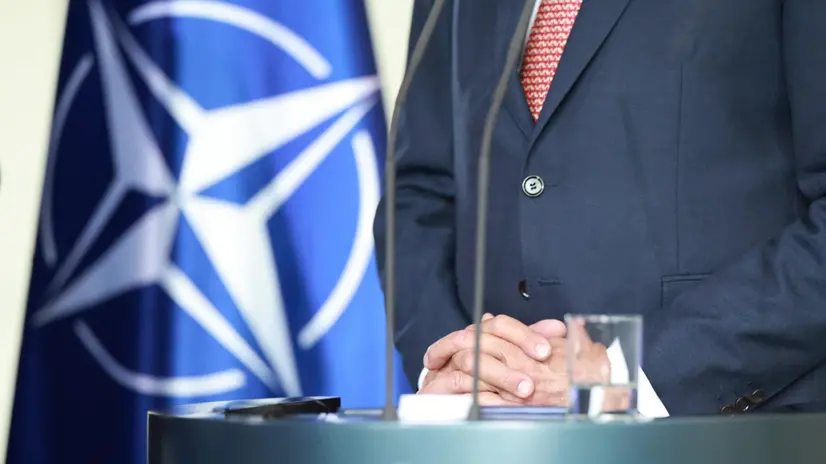 epa12227108 German Chancellor Friedrich Merz stands next to a NATO flag during a press conference with NATO Secretary-General Mark Rutte (not seen) at the Chancellery in Berlin, Germany, 09 July 2025. EPA/CLEMENS BILAN