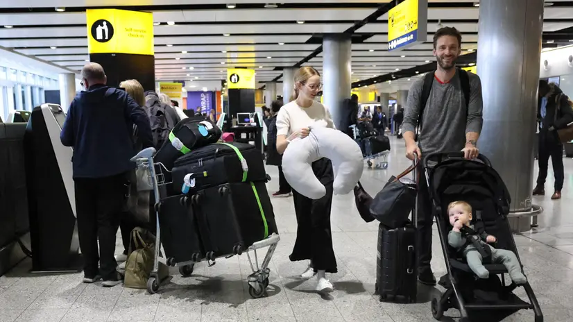 epa11980566 Passengers walk with their luggage at a departure lounge of Heathrow Airport in Hounslow, Britain, 22 March 2025. Flights resumed at Heathrow Airport following a power outage on 21 March 2025. A fire at a substation which supplies power to Heathrow forced its closure for most of 21 March, leading to thousands of cancelled flights and stranding passengers across the world. Heathrow is Europe's busiest Airport and the Metropolitan Police’s Counter Terrorism Command is leading the investigation into the cause of the fire at the electrical substation. EPA/NEIL HALL