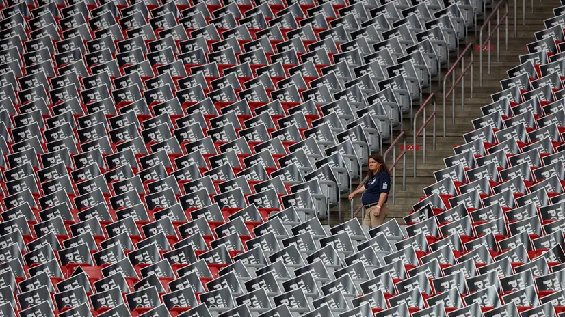 epa12395892 A woman stands inside State Farm Stadium ahead of the public memorial service of political activist Charlie Kirk, in Glendale, Arizona, USA, 21 September 2025. Kirk was shot and killed on 10 September during a stop on his American Comeback Tour organized by Turning Point USA at Utah Valley University. EPA/CAROLINE BREHMAN