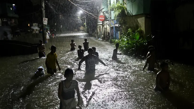 epaselect epa12251643 Residents wade on floodwater in the flood-hit city of Marikina, Metro Manila, Philippines, 21 July 2025. The Philippine weather bureau on July 21 was monitoring two low pressure areas inside the Philippine area that have the potential to develop into a tropical cyclone as Typhoon Wipha left the country leaving at least five people dead. EPA/FRANCIS R. MALASIG