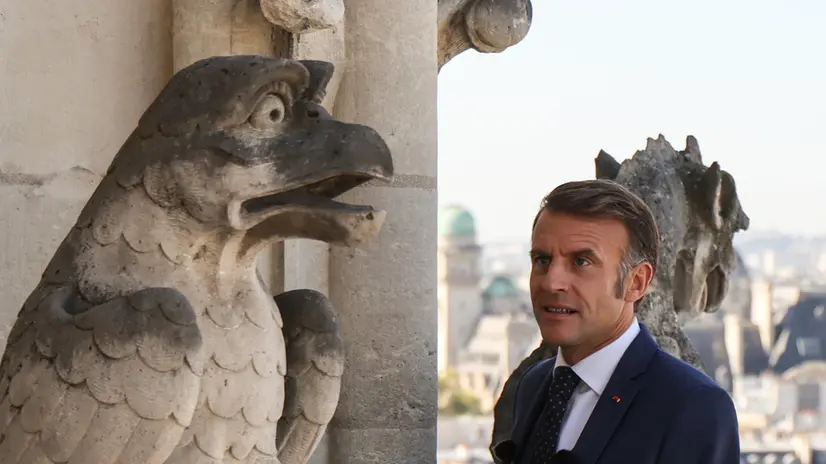 epa12389535 France's President Emmanuel Macron looks at a gargoyle as he visits Notre-Dame de Paris Cathedral during the inauguration ceremony of the new tour route of the Cathedral Towers Gothic structures destroyed following the April 2019 fire, as part of the 42nd edition of the European Heritage Days in Paris, France, 19 September 2025. The 15 April 2019 fire destroyed the roof and steeple of the 850-year-old Gothic cathedral. Notre Dame Cathedral reopened in December 2024 for services and visits. EPA/LUDOVIC MARIN / POOL MAXPPP OUT