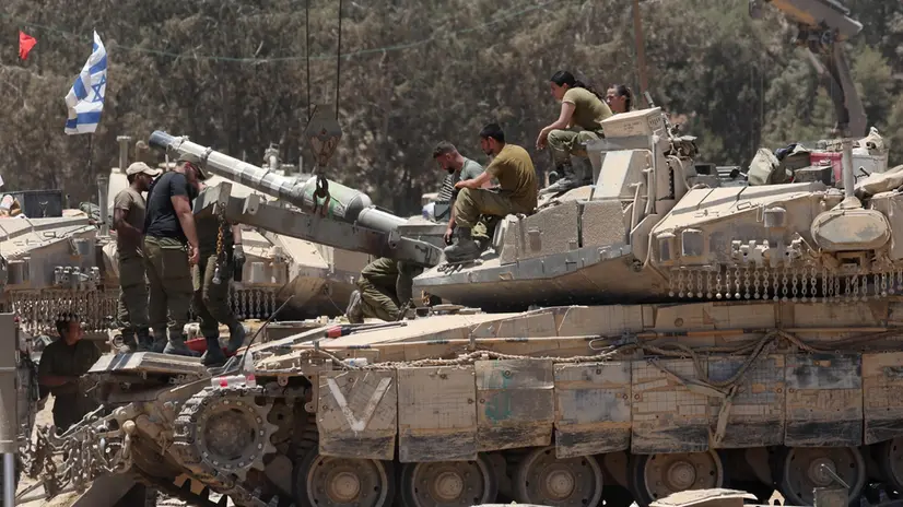 epa11452031 Israeli soldiers on a tank at an undisclosed location near the border with the Gaza Strip, southern Israel, 02 July 2024. The Israeli military stated on 02 July that it continued operations in the areas of Shejaiya, Rafah, and central Gaza. More than 37,000 Palestinians and over 1,400 Israelis have been killed, according to the Palestinian Health Ministry and the Israel Defense Forces (IDF), since Hamas militants launched an attack against Israel from the Gaza Strip on 07 October 2023, and the Israeli operations in Gaza and the West Bank which followed it. EPA/ABIR SULTAN