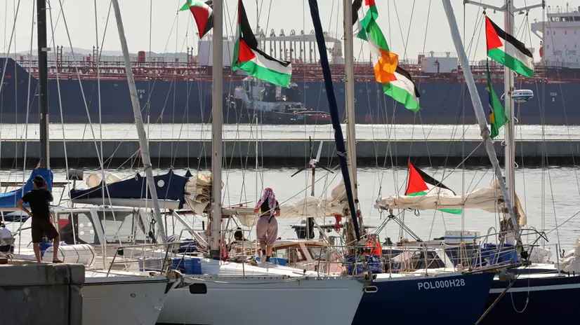 epa12372804 Participants of the Global Sumud Flotilla (GSF) wait to set sail towards Gaza along with other boats at the port of Bizerte, Tunisia, 13 September 2025. The Gaza-bound GSF flotilla is an international maritime initiative that began sailing in August 2025, aiming to break the Israeli blockade and deliver vital aid to the Gaza Strip. EPA/MOHAMED MESSARA
