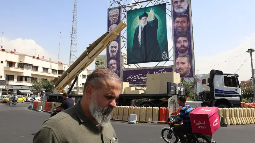 epa12409856 An Iranian Kheibar-Shekan medium-range ballistic missile (MRBM) placed next to a large banner depicting Iranian supreme leader Ayatollah Ali Khamenei (C) in Baharestan Square in Tehran, Iran, 27 September 2025. According to state media, Iran has recalled its envoys to Britain, France, and Germany for consultations after the three countries (E3) initiated a 'snapback' process to restore UN sanctions over Iran's alleged failure to meet its nuclear program commitments. EPA/ABEDIN TAHERKENAREH