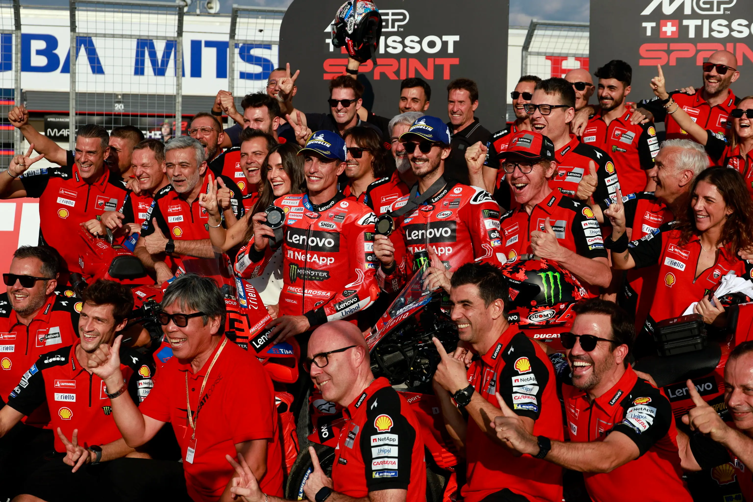 epa12409224 Sprint race winner Ducati Lenovo Team rider Francesco Bagnaia (C-R) of Italy and second placed Ducati Lenovo Team rider Marc Marquez (C-L) of Spain pose with their team members after the sprint race of the Motorcycling Grand Prix of Japan in Motegi, Tochigi Prefecture, northeastern Japan, 27 September 2025. The Motorcycling Grand Prix of Japan will take place on 28 September 2025. EPA/FRANCK ROBICHON