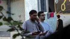 epa12420610 People use a mobile phones as internet and telecom services are gradually restoring after almost three days of closures in Kabul, Afghanistan, 01 October 2025. Afghanistan restored mobile networks and the internet on 01 October after a two-day nationwide shutdown ordered by Taliban authorities. The blackout halted businesses, banks, and travel, leaving the country nearly cut off. Netblocks called it a deliberate disconnection. Connectivity’s return sparked street celebrations in Kabul, with residents likening the moment to a holiday. EPA/SAMIULLAH POPAL