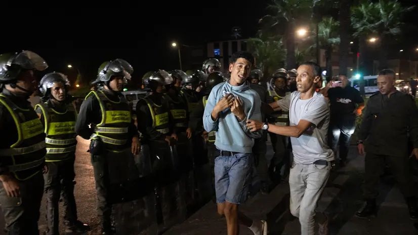 epa12422419 A protester (C) is seen being detained during a gathering of youth-led protests demanding healthcare and education reforms turns violent, in Sale, Morocco, 01 October 2025. EPA/Jalal Morchidi