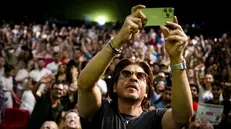 epa11545755 Indian actor Shah Rukh Khan takes a selfie with fans during a conversation with the audience at the 77th Locarno International Film Festival, in Locarno, Switzerland, 11 August 2024. Khan received the Pardo alla Carriera Ascona-Locarno Tourism award, the festival's career achievement award, during a ceremony at the Piazza Grande on 10 August. The festival runs from 07 to 17 August 2024. EPA/JEAN-CHRISTOPHE BOTT