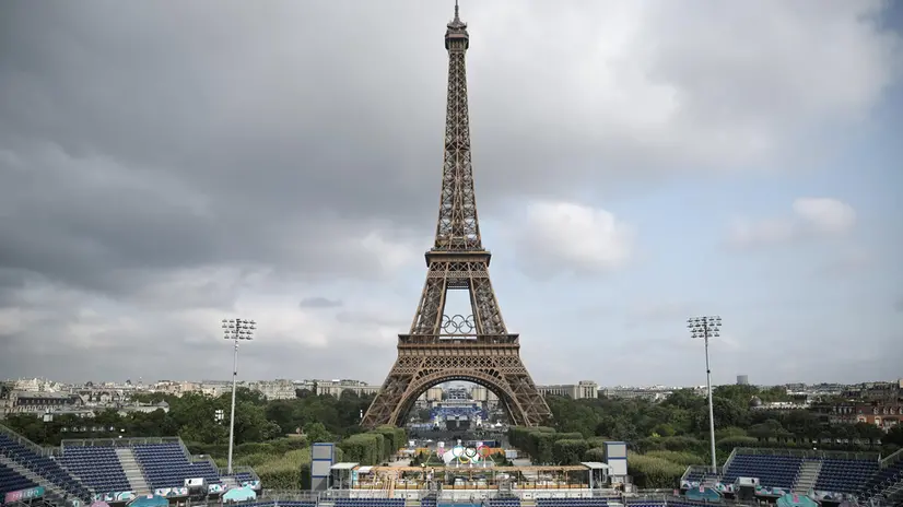 epa11493543 The Eiffel Tower is seen near 'Stade Tour Eiffel' before the French president's visit, in Champs de Mars in Paris, France, 24 July 2024. 'Stade Tour Eiffel' will host beach volleyball and blind football during the 2024 Summer Olympics which will be held in Paris from 26 July to 11 August 2024 and the Paralympic Games from 28 August to 08 September 2024. EPA/CHRISTOPHE PETIT TESSON / POOL