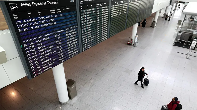 epa11133341 Passengers look at the flights' display board marking limited air traffic at the Munich International Airport during a Lufthansa warning strike in Munich, Germany, 07 February 2024. The ver.di trade union has called on Lufthansa's ground staff to go on a 27-hour warning strike from 4:00 am on 07 February until 08 February morning. The action will affect Frankfurt am Main, Munich, Hamburg, Berlin and Dusseldorf airports. EPA/ANNA SZILAGYI