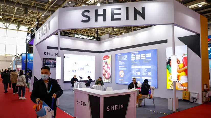 epa11000490 A man walks next to a Shein booth during the China International Supply Chain Expo in Beijing, China, 29 November 2023. China is holding its first China International Supply Chain Expo in Beijing from 28 November to 02 December with the theme of 'Connecting the World for a Shared Future'. EPA/MARK R. CRISTINO