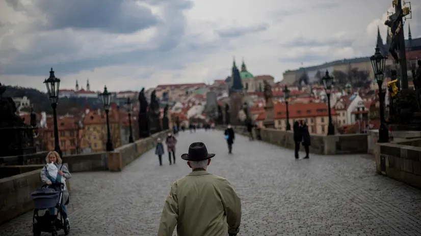 epa09132744 A man walks on Charles Bridge in Prague, Czech Republic, 13 April 2021. The Czech Republic reported its lowest daily coronavirus cases since September on 12 April 2021. According to Czech Ministry of Health, more than 28.000 people died during the COVID-19 pandemic. EPA/MARTIN DIVISEK