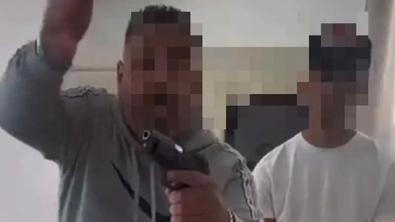 Un frame dove l'uomo minaccia con la pistola il suo interlocutore - © www.giornaledibrescia.it