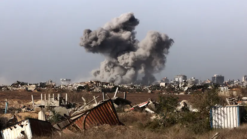 epa12430672 A photo taken while embedded with the Israeli Army and a plume of smoke rising above Gaza City during an Israeli strike in Gaza City, 03 October 2025 (issued 04 October 2025). Israel's military said on 04 October to advance readiness for the implementation of the first phase of the Trump plan for the release of the hostages while the same time make the safety of IDF troops a top priority and allocate all IDF capabilities to the Southern Command to ensure the protection of the troops. EPA/JACK GUEZ / POOL --PHOTO TAKEN DURING A CONTROLLED TOUR AND SUBSEQUENTLY EDITED UNDER THE SUPERVISION OF THE ISRAELI MILITARY--
