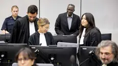 epa10927291 Sudanese former militia chief Ali Muhammad Ali Abd al-Rahman (3-R) and Dr. Cyril Laucci (R), chief advisor to Mr. Abd-Al-Rahman during a hearing at the International Criminal Court (ICC) in The Hague, The Netherlands, 19 October 2023. The Sudanese former militia chief is on trial for 31 war crimes and crimes against humanity, including murder, rape and torture allegedly committed in Darfur in 2003 to 2004. EPA/KOEN VAN WEEL / POOL