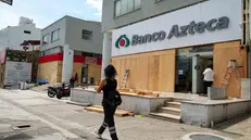 epa12184549 A woman walks in front of an establishment protected with plywood ahead of the arrival of hurricane Erick, in the beach resort of Acapulco in Guerrero, Mexico, 18 June 2025. Hurricane Erick intensified to a category 2 on the Saffir-Simpson scale as it approaches the coasts of Guerrero and Oaxaca in southern Mexico, where it could make landfall early on 19 June as a category 3. EPA/DAVID GUZMAN