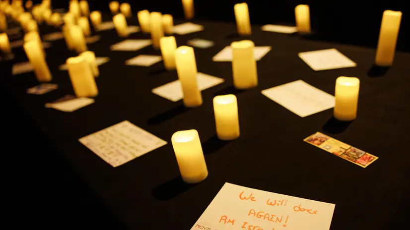 epa12434947 A message that reads 'We will dance again! Am Israel Chai' lies between artificial candles during a press day prior to the opening of the Nova Music Festival exhibition at former Tempelhof Airport in Berlin, Germany, 06 October 2025. The Nova Music Festival exhibition opens to the public on 07 October 2025, two years after the deadly Hamas terror on 07 October 2023 took place. EPA/CLEMENS BILAN
