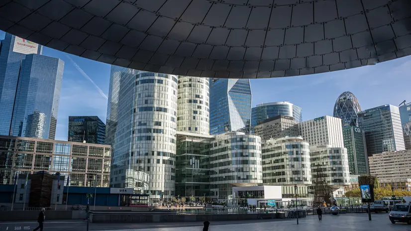 epa10281660 Pedestrians walk past buildings in the La Defense business district outside Paris, France, 02 November 2022. EPA/CHRISTOPHE PETIT TESSON