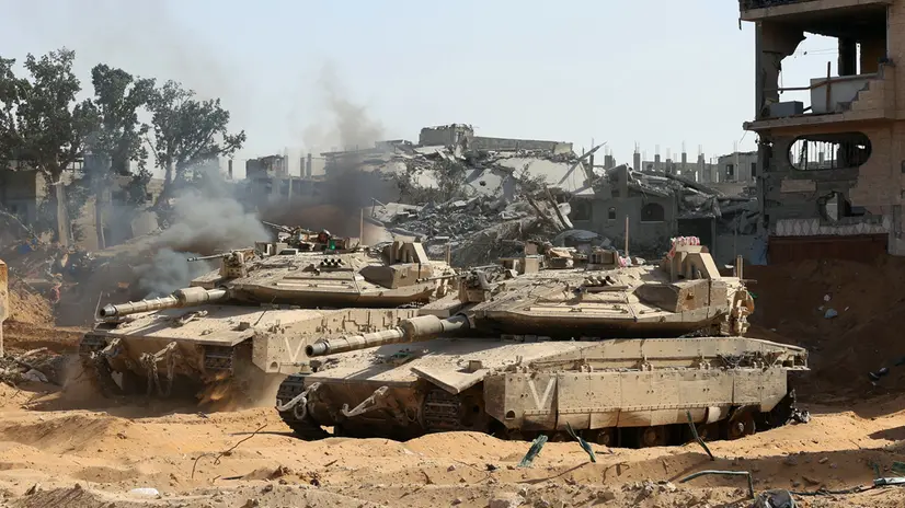 epa12430670 A photo taken while embedded with the Israeli Army and cleared by Israeli military censors shows Israeli army tanks in front of war-destroyed buildings in the vicinity of the Jordanian Field Hospital in Gaza City, 03 October 2025 (issued 04 October 2025). Israel's military said on 04 October to advance readiness for the implementation of the first phase of the Trump plan for the release of the hostages while the same time make the safety of IDF troops a top priority and allocate all IDF capabilities to the Southern Command to ensure the protection of the troops. EPA/JACK GUEZ / POOL --PHOTO TAKEN DURING A CONTROLLED TOUR AND SUBSEQUENTLY EDITED UNDER THE SUPERVISION OF THE ISRAELI MILITARY--