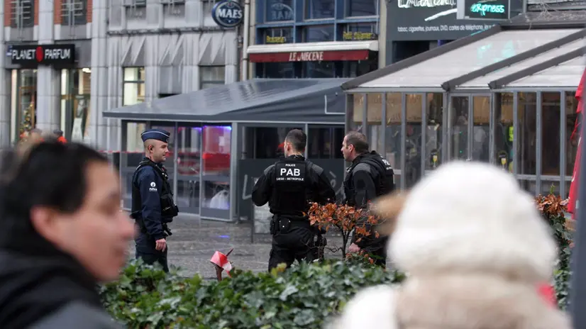 epa03032869 Police officers secure a cordoned off area in Liege, Belgium, 13 December 2011. The death toll from the grenade attack which took place 13 December in the Belgian city of Liege has risen to four, judicial sources told the Belga news agency. One of the victims was the attacker, who was named by media as Nordine Amrani, a 32-year-old man who had been convicted in 2008 for the illegal possession of firearms and running a cannabis plantation as part of a criminal gang. His car was found near the place of the attack and was blown up by special police forces. Contradicting earlier press reports, no other people were said to be involved in the attack. EPA/RALF ROEGER