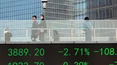 epa10525850 People cross the pedestrian bridge with a screen showing the latest stock exchange data in Lujiazui main financial district of Shanghai, China, 16 March 2023. Asia-Pacific markets fall as global banking fear of a more significant bank crisis. Shanghai, Tokyo, and Hong Kong dropped on 16 March, reversing the day before's gains. The Chinese Shanghai Composite Index closed the day at 1.12 percent, Shenzhen Component Index at 1.54 percent, Hong Kong's Hang Seng at 1.64 percent, and the Japanese Nikkei 225 at 0.80 percent. EPA/ALEX PLAVEVSKI