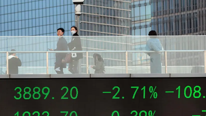 epa10525850 People cross the pedestrian bridge with a screen showing the latest stock exchange data in Lujiazui main financial district of Shanghai, China, 16 March 2023. Asia-Pacific markets fall as global banking fear of a more significant bank crisis. Shanghai, Tokyo, and Hong Kong dropped on 16 March, reversing the day before's gains. The Chinese Shanghai Composite Index closed the day at 1.12 percent, Shenzhen Component Index at 1.54 percent, Hong Kong's Hang Seng at 1.64 percent, and the Japanese Nikkei 225 at 0.80 percent. EPA/ALEX PLAVEVSKI