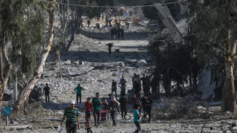 epa12444162 Palestinians walk along a street amid the rubble of destroyed buildings during a ceasefire between Israel and Hamas under the first phase of the Gaza peace plan, in Gaza City, Gaza Strip, 10 October 2025. Prime Minister Benjamin Netanyahu's office announced on 09 October that the Israeli government had approved the Gaza ceasefire and hostage release plan. EPA/MOHAMMED SABER