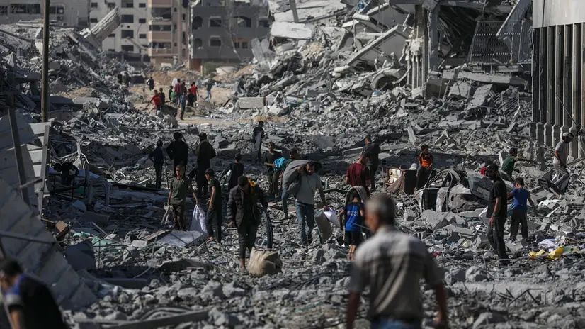 epa12444156 Palestinians walk along a street amid the rubble of destroyed buildings during a ceasefire between Israel and Hamas under the first phase of the Gaza peace plan, in Gaza City, Gaza Strip, 10 October 2025. Prime Minister Benjamin Netanyahu's office announced on 09 October that the Israeli government had approved the Gaza ceasefire and hostage release plan. EPA/MOHAMMED SABER