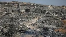epa12447088 Internally displaced Palestinians walk along a street among the rubble of destroyed buildings amid a ceasefire between Israel and Hamas, in Gaza City, 11 October 2025. US President Donald Trump announced that Israel and Hamas have agreed to the first phase of a Gaza peace plan. The deal involves the release of Israeli hostages and Palestinian prisoners, the withdrawal of Israeli forces, and the delivery of humanitarian aid to Gaza. EPA/MOHAMMED SABER