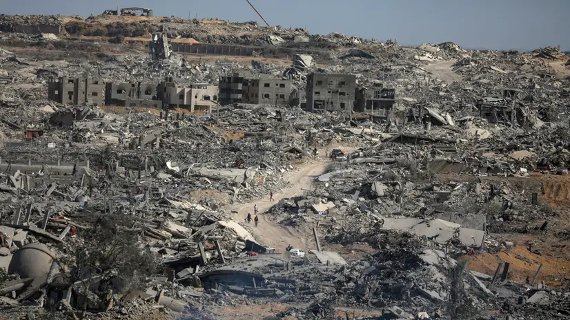 epa12447088 Internally displaced Palestinians walk along a street among the rubble of destroyed buildings amid a ceasefire between Israel and Hamas, in Gaza City, 11 October 2025. US President Donald Trump announced that Israel and Hamas have agreed to the first phase of a Gaza peace plan. The deal involves the release of Israeli hostages and Palestinian prisoners, the withdrawal of Israeli forces, and the delivery of humanitarian aid to Gaza. EPA/MOHAMMED SABER