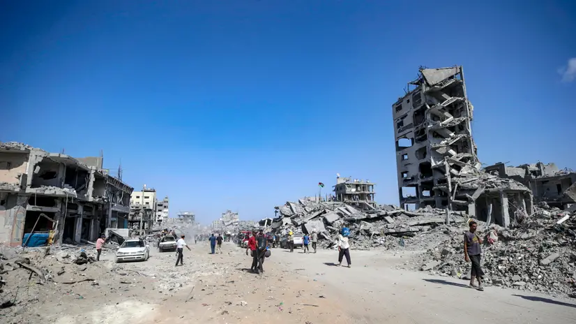 epa12447008 Palestinians walk along a street among the rubble of destroyed buildings amid a ceasefire between Israel and Hamas, in Gaza City, 11 October 2025. US President Donald Trump announced that Israel and Hamas have agreed to the first phase of a Gaza peace plan. The deal involves the release of Israeli hostages and Palestinian prisoners, the withdrawal of Israeli forces, and the delivery of humanitarian aid to Gaza. EPA/MOHAMMED SABER