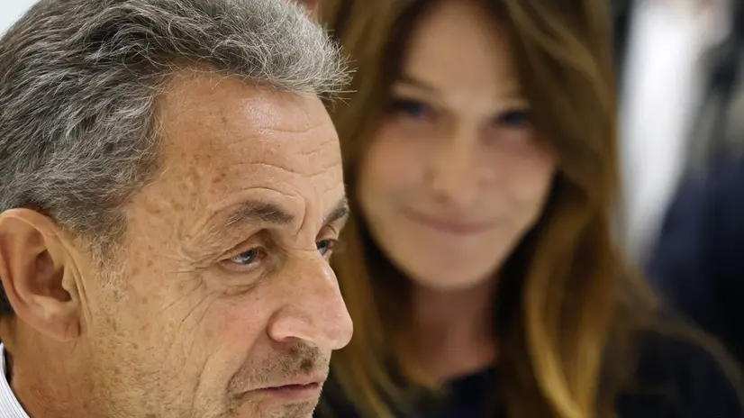 epaselect epa12404537 Former French president Nicolas Sarkozy (L) and his wife, Carla Bruni-Sarkozy (R), leave the courthouse in Paris, France, 25 September 2025. Sarkozy and twelve others, including three former ministers, stood trial for criminal conspiracy to receive funds for the 2007 presidential campaign from the regime of late Libyan leader Muammar Gaddafi, and he has now been sentenced to five years in jail for his role in the case involving funds from Gaddafi. Sarkozy has been convicted twice in separate cases since leaving office in 2012. EPA/YOAN VALAT