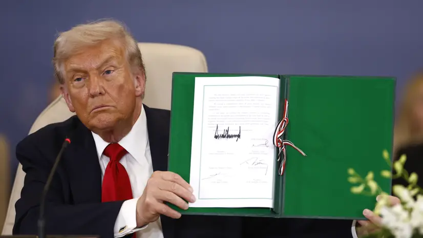 epa12451405 US President Donald Trump shows a signed document at the Gaza Peace Summit in Sharm El-Sheikh, Egypt, 13 October 2025. US President Donald Trump alongside Egypt's President Abdel Fattah al-Sisi with leaders from more than 20 countries attend the summit in Sharm El-Sheikh. The first phase of Gaza peace plan between Israel and Hamas involves the release of Israeli hostages and Palestinian prisoners, the partial withdrawal of Israeli forces, and the delivery of humanitarian aid to Gaza. EPA/YOAN VALAT / POOL