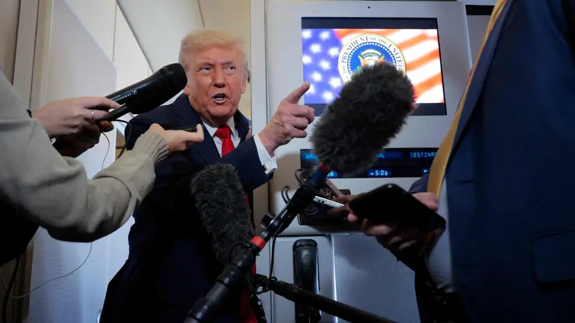 ABOARD AIR FORCE ONE - OCTOBER 12: US President Donald Trump talks to reporters on board Air Force One en route to Israel on October 12, 2025 at Joint Base Andrews, Maryland. Trump is traveling to the Middle East to meet with officials in Israel and Egypt and mark the beginning of his proposed peace plan for the Gaza Strip. Chip Somodevilla/Getty Images/AFP (Photo by CHIP SOMODEVILLA / GETTY IMAGES NORTH AMERICA / Getty Images via AFP)