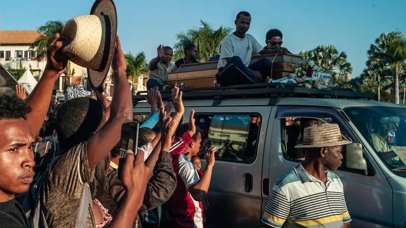 epa12451677 Family and friends of Safidy Nantenaina Rakotoarisoa, a protester killed by police on 12 October, carry his coffin outside City Hall in Antananarivo, Madagascar, 13 October 2025. Madagascar's embattled President Andry Rajoelina has denounced a coup attempt after CAPSAT, an elite army unit, has refused to shoot on unarmed protesters and decided to join them instead. EPA/HENITSOA RAFALIA