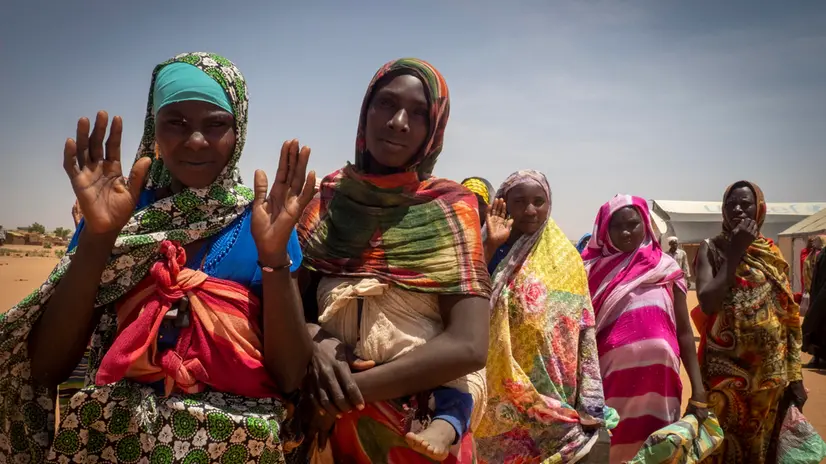 epa11275410 Refugee women from West Darfur wait to get a pack of food for four days from workers of the World Food Programme (WFP) and Red Cross, in a refugee camp in Adre, Chad, on the border with Sudan, 12 April 2024. Most of the refugees are women and children fleeing the hunger crisis because of the war which started on 15 April 2023. According to the UNHCR in March 2024, in one year more than 500,00 Sudanese refugees, mainly from Darfur region, have crossed into Chad looking for safety, 90 percent of them are women and children. As different humanitarian crises are unfolding in other parts of the world, both the UN and NGOs like Doctors Without Borders/Médecins Sans Frontières (MSF) keep appealing for more aid to reach Sudan and avoid a looming famine situation in the already strained socio-economic context of Chad. EPA/STRINGER