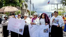 epa12457192 People hold signs during a demonstration in Otavalo, Ecuador, 15 October 2025. The Ecuadorian government reached a truce with indigenous leaders who had been leading protests against Ecuadorian President Daniel Noboa in the province of Imbabura, the epicenter of the demonstrations. However, this was not endorsed by the communities, who are advocating for the roadblocks to remain in place after a second protester was killed, allegedly by shots fired by state forces. EPA/Washington Benalcazar