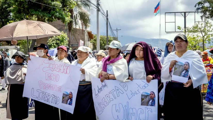 epa12457192 People hold signs during a demonstration in Otavalo, Ecuador, 15 October 2025. The Ecuadorian government reached a truce with indigenous leaders who had been leading protests against Ecuadorian President Daniel Noboa in the province of Imbabura, the epicenter of the demonstrations. However, this was not endorsed by the communities, who are advocating for the roadblocks to remain in place after a second protester was killed, allegedly by shots fired by state forces. EPA/Washington Benalcazar