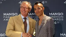 epa03242175 Spanish fashion brand MANGO's President, Isak Andic (L), and Thai fashion designer Wisharawish Akaransantisook, 30, pose for photographer after it was announced that Akaransantisook had been awarded 4th MANGO Fashion Award in Barcelona, northeastern Spain, 30 May 2012. The Award, worth at 300,000euro, will be handed over later on 30 May during a gala at Barcelona's Palau Nacional de Montjuic. EPA/TONI ALBIR