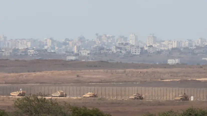 epa11645083 A convoy of Israeli armoured vehicles makes its way to the northern Gaza Strip, as seen from the border with Gaza in southern Israel, 06 October 2024. Israel's military stated on 06 October, they have been conducting since last night an 'operation to systematically dismantle terrorist infrastructure' in the area of Jabalia, in the northern Gaza Strip. The Israel Air Force conducted strikes on dozens of military targets in order to assist IDF ground troops operating in the area, the statement added. EPA/ABIR SULTAN