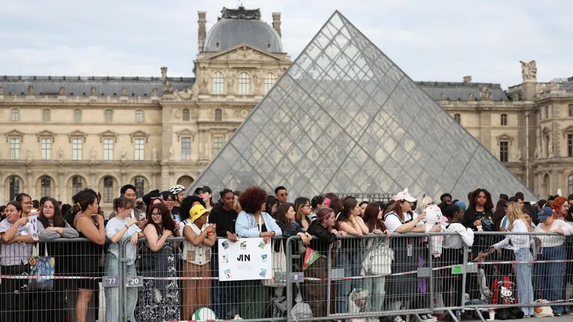epa11478389 BTS fans wait for K-Pop superstar Kim Soek-Jin at the Louvres Pyramid as the Olympic Torch Relay arrives in Paris, France, 14 July 2024. The Olympic torch relay arrived in Paris on Bastille Day, the country's national holiday, and will visit some of the city's most famous landmarks on 14 and 15 July. In May 2024, the Olympic flame began its journey across France, including five overseas regions, visiting hundreds of towns and cities before the Olympic Games Opening Ceremony on 26 July. EPA/JULIEN MATTIA