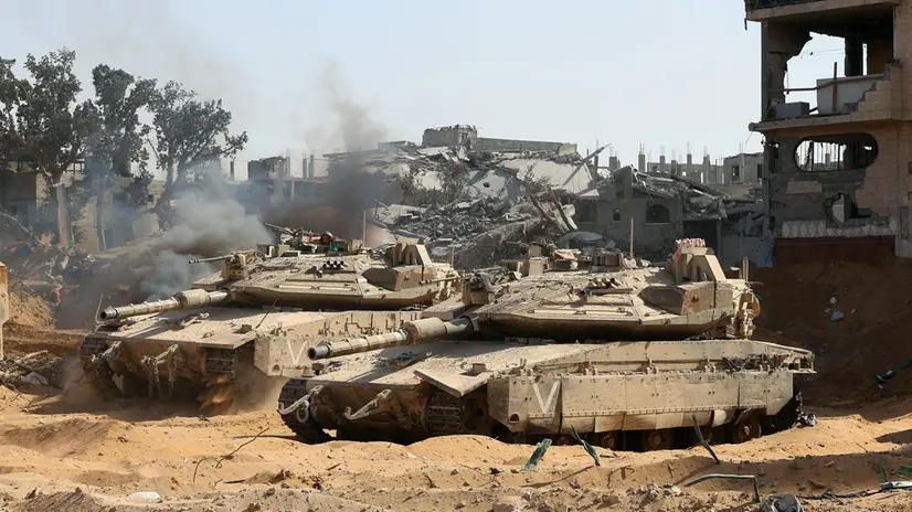 epa12430670 A photo taken while embedded with the Israeli Army and cleared by Israeli military censors shows Israeli army tanks in front of war-destroyed buildings in the vicinity of the Jordanian Field Hospital in Gaza City, 03 October 2025 (issued 04 October 2025). Israel's military said on 04 October to advance readiness for the implementation of the first phase of the Trump plan for the release of the hostages while the same time make the safety of IDF troops a top priority and allocate all IDF capabilities to the Southern Command to ensure the protection of the troops. EPA/JACK GUEZ / POOL --PHOTO TAKEN DURING A CONTROLLED TOUR AND SUBSEQUENTLY EDITED UNDER THE SUPERVISION OF THE ISRAELI MILITARY--