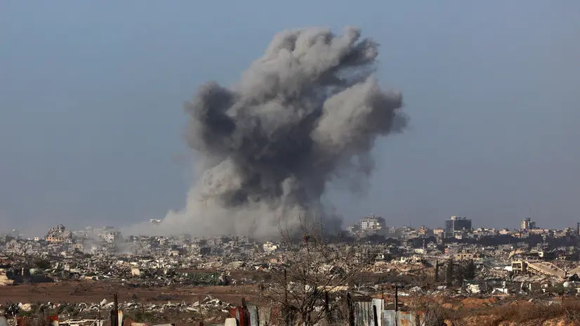 epa12430668 A photo taken while embedded with the Israeli Army and cleared by Israeli military censors shows a plume of smoke rising above Gaza City during an Israeli strike in Gaza City, 03 October 2025 (issued 04 October 2025). Israel's military said on 04 October to advance readiness for the implementation of the first phase of the Trump plan for the release of the hostages while the same time make the safety of IDF troops a top priority and allocate all IDF capabilities to the Southern Command to ensure the protection of the troops. EPA/JACK GUEZ / POOL --PHOTO TAKEN DURING A CONTROLLED TOUR AND SUBSEQUENTLY EDITED UNDER THE SUPERVISION OF THE ISRAELI MILITARY--
