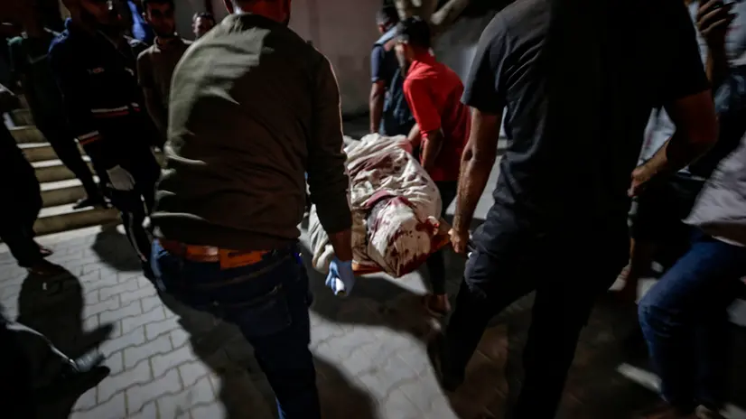 epa12465507 The body of a man is delivered to Al Shifa hospital following an Israeli air strike at Al Andalousia Building in the west of Gaza City, 19 October 2025. According to the Palestinian Ministry of Health in Gaza, at least one Palestinian was killed and several others wounded in the attack. EPA/MOHAMMED SABER