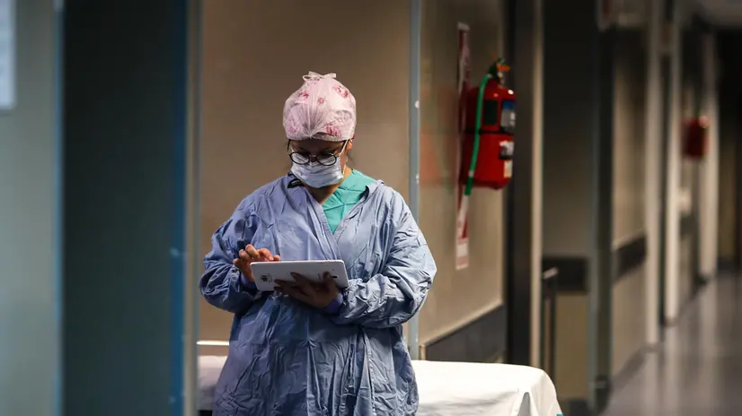 epa08575608 A doctor checks a tablet at a hallway of El Cruce de Florencio Varela Hospital in Buenos Aires, Argentina, 30 July 2020. EPA/JUAN IGNACIO RONCORONI