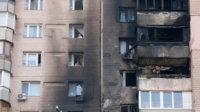 epa12472180 Local people look through broken windows of a damaged residential building at the site of an overnight Russian strike in Kyiv, Ukraine, 22 October 2025, amid the ongoing Russian invasion. At least two people were killed and more than 20 others injured, including five children, after Russian strikes on Kyiv, the State Emergency Service of Ukraine reported. Across Ukraine, the attacks killed at least seven people, including two children, with regions including Kyiv, Odesa, Chernihiv, Dnipropetrovsk, Kirovohrad, Poltava, Vinnytsia, Zaporizhia, Cherkasy, and Sumy affected, according to President Zelensky. EPA/SERGEY DOLZHENKO