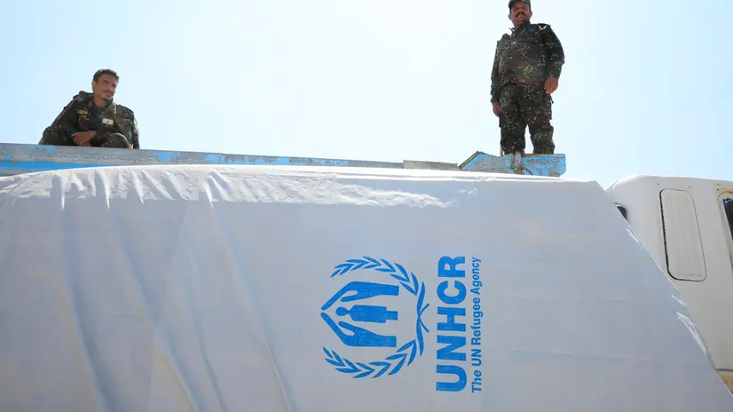 epa12468014 Houthi soldiers keep watch near a plastic tarpaulin with the UNHCR logo covering a vehicle, in Sana'a, Yemen, 20 October 2025. The United Nations said in a statement that Yemen's Houthis have released 20 UN staff who had been detained two days ago during a raid carried out by Houthi forces on a UN compound in Sana'a. The Houthis are continuing to detain dozens of staffers belong to multiple UN agencies working in Houthi-held areas of Yemen, accusing some of them of spying for the US and Israel and identifying targets for the Israeli bombings that killed several Houthi officials in Sana'a in recent months. EPA/YAHYA ARHAB